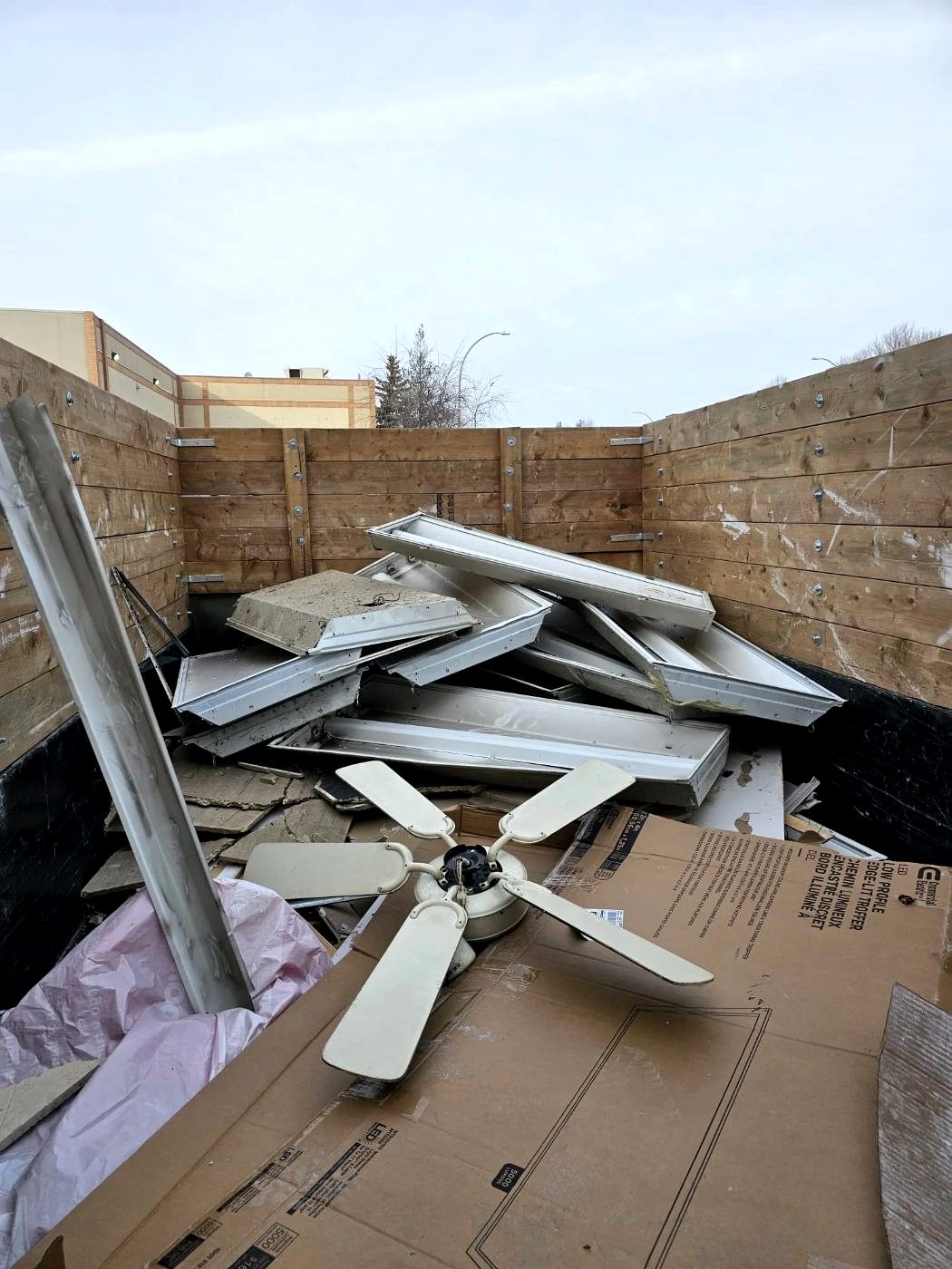 Stripped fixtures and frames stacked for disposal