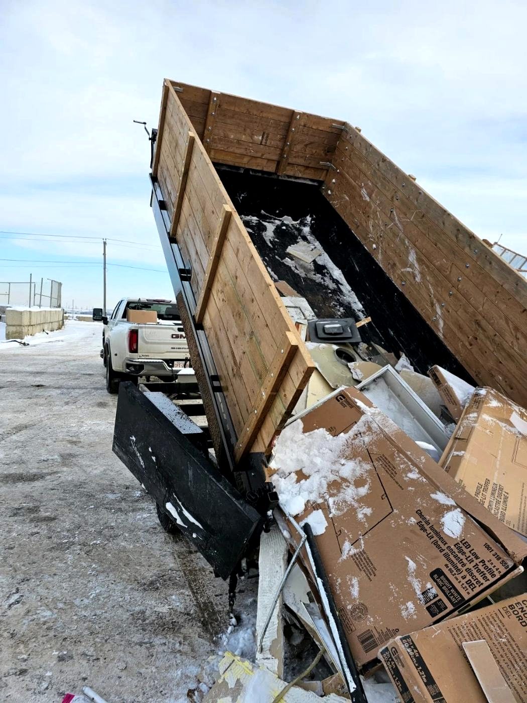 Trailer loaded with demolition debris leaving a cleared site
