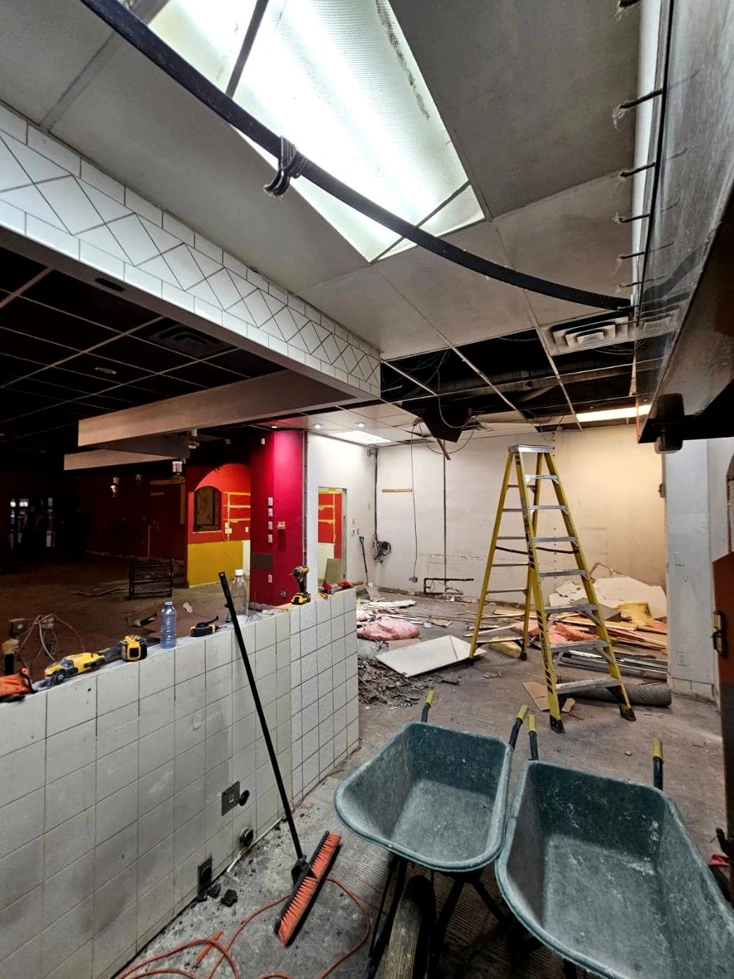 Commercial interior strip-out with the ceiling grid removed