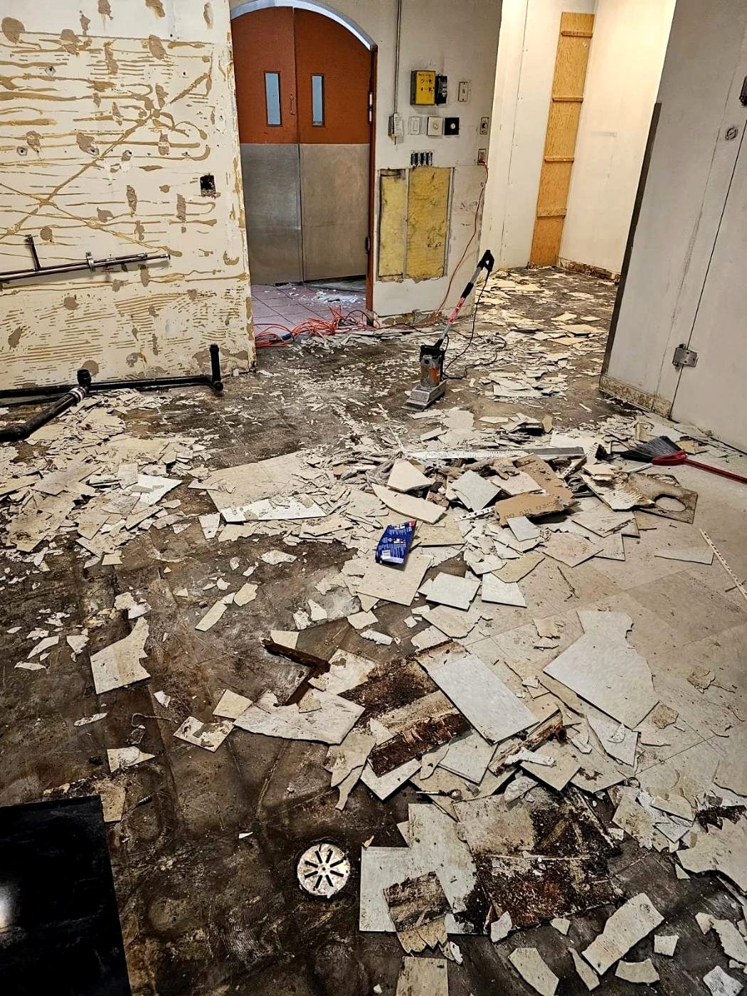 Commercial flooring broken up and staged for removal