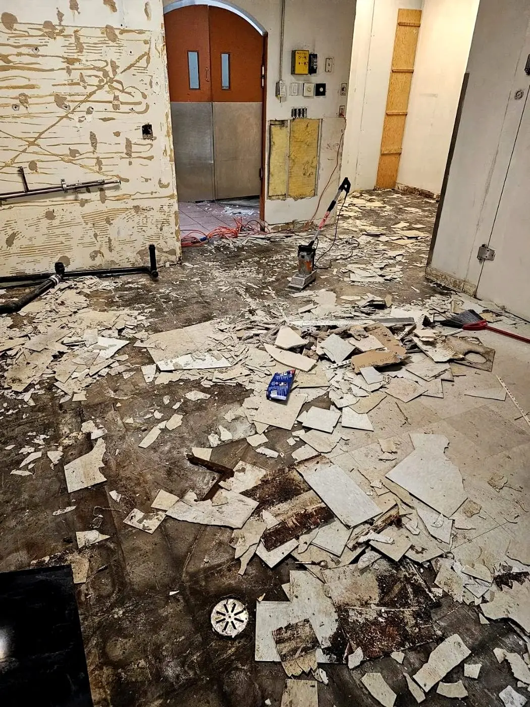 Commercial flooring broken up and staged for removal