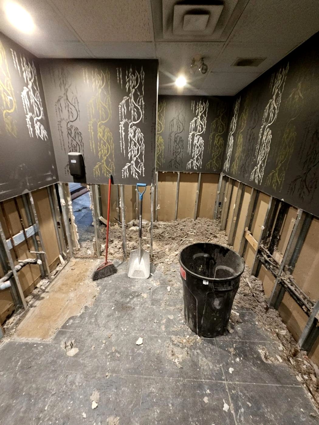Wall stripped back exposing the services behind the finish